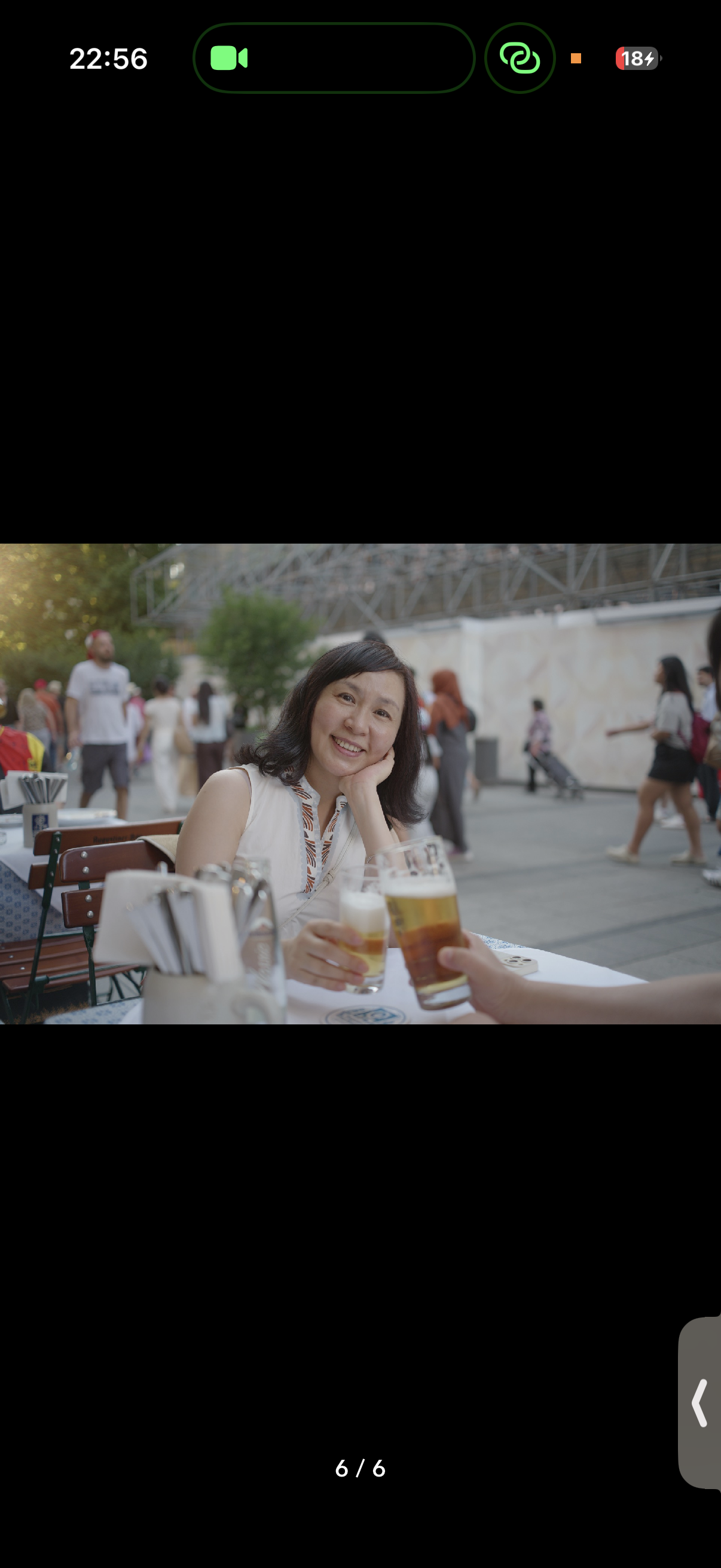 Raising a glass at an outdoor table.
