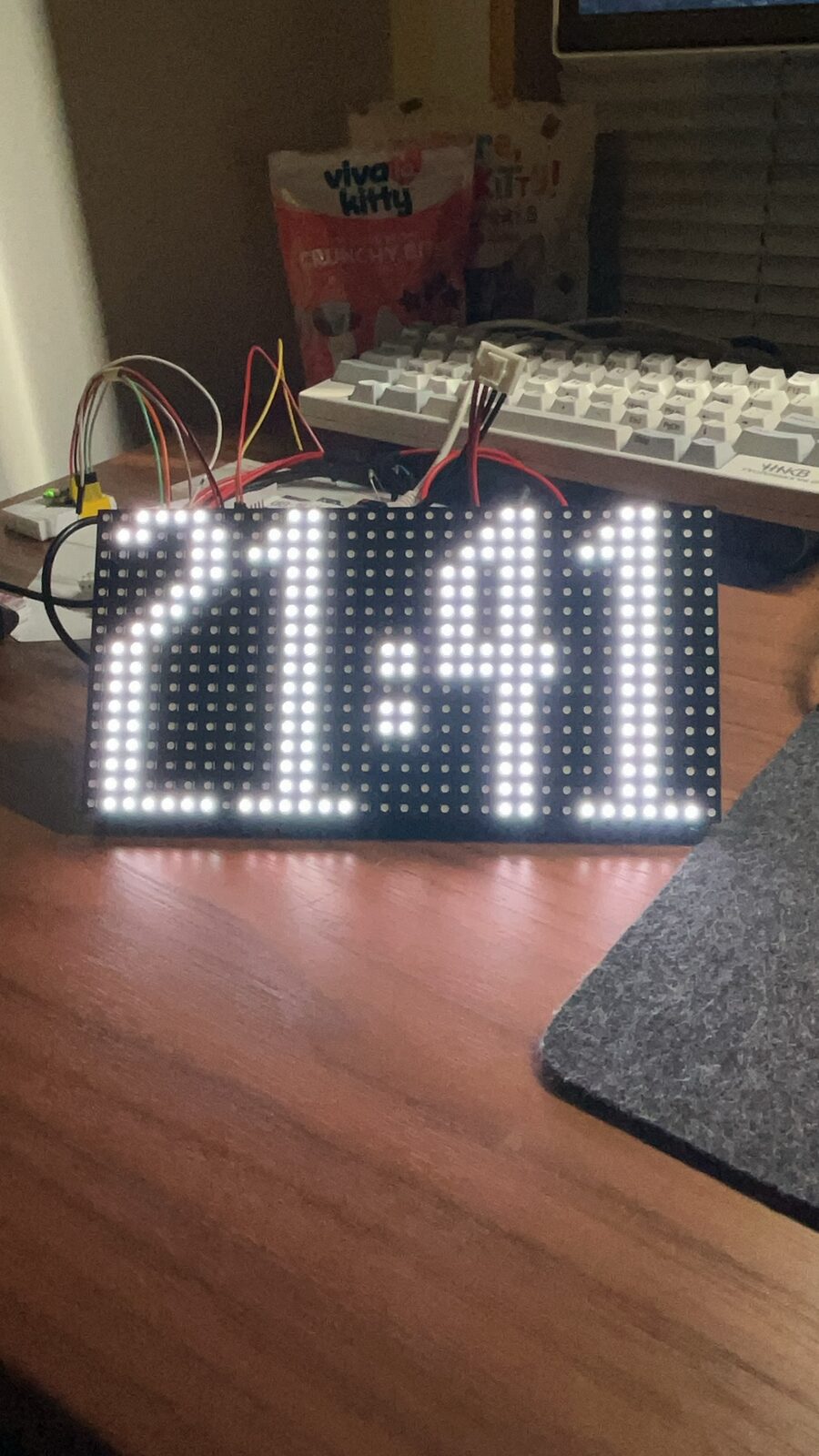 Three connected RGB LED panels displaying a digital time during development.
