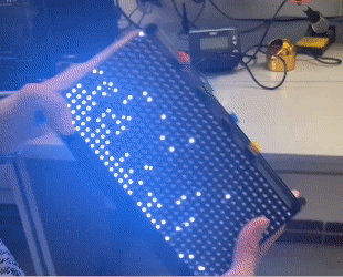 Simulated snowflakes falling and bouncing in response to the clock's orientation.